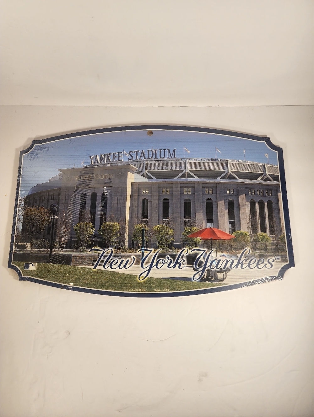 Decorative wall plaque featuring a photograph of Yankee Stadium.
